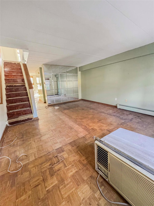 basement featuring parquet floors and a baseboard radiator