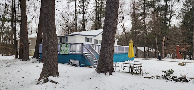 view of snow covered rear of property