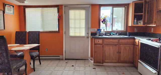 kitchen featuring electric stove, sink, and a baseboard radiator