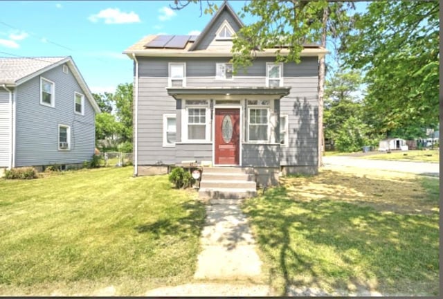 47 Prince St, Middletown, NY 10940 - view of front of property with a front yard and roof mounted solar panels