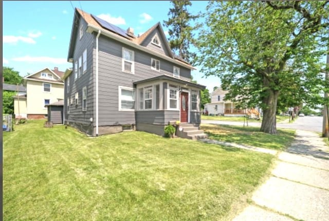 47 Prince St, Middletown, NY 10940 - american foursquare style home with a front lawn, entry steps, and solar panels