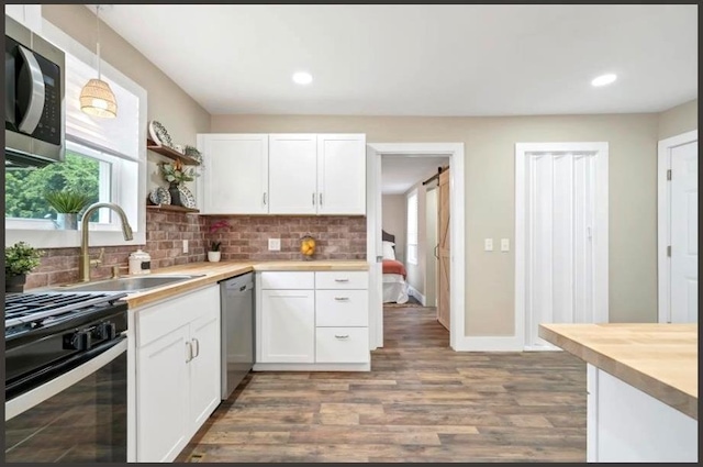 47 Prince St, Middletown, NY 10940 - kitchen featuring stainless steel appliances, a sink, open shelves, white cabinetry, and decorative backsplash