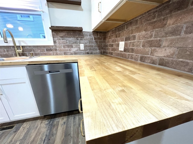 47 Prince St, Middletown, NY 10940 - kitchen featuring stainless steel dishwasher, dark wood-style flooring, white cabinets, a sink, and wooden counters