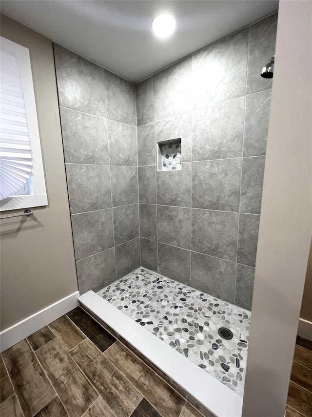 47 Prince St, Middletown, NY 10940 - bathroom featuring a tile shower, wood finished floors, and baseboards