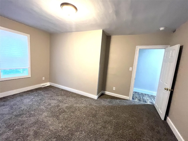 47 Prince St, Middletown, NY 10940 - unfurnished room with dark colored carpet, baseboards, and a smoke detector
