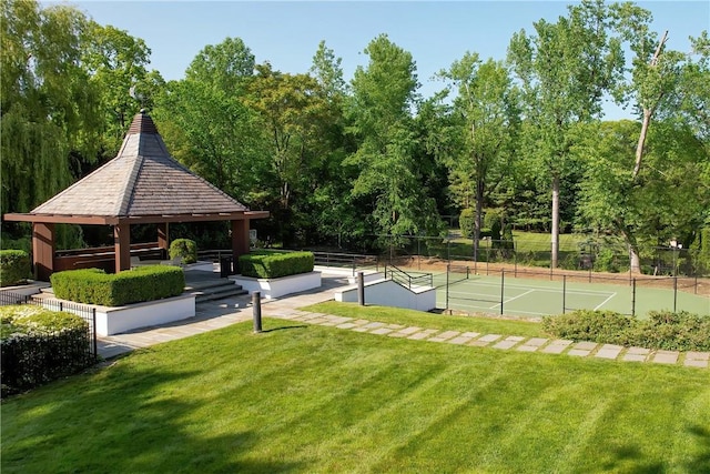 view of home's community with a gazebo, a lawn, and tennis court