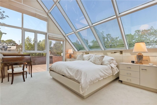 bedroom featuring light carpet and high vaulted ceiling