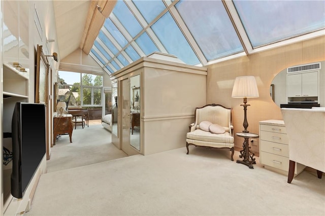 sunroom / solarium featuring vaulted ceiling with skylight