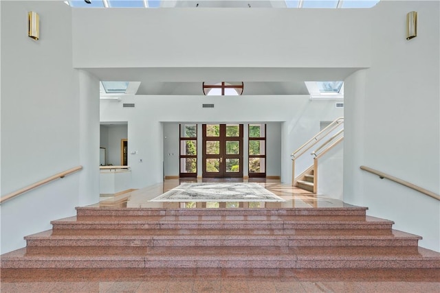 stairway featuring a high ceiling