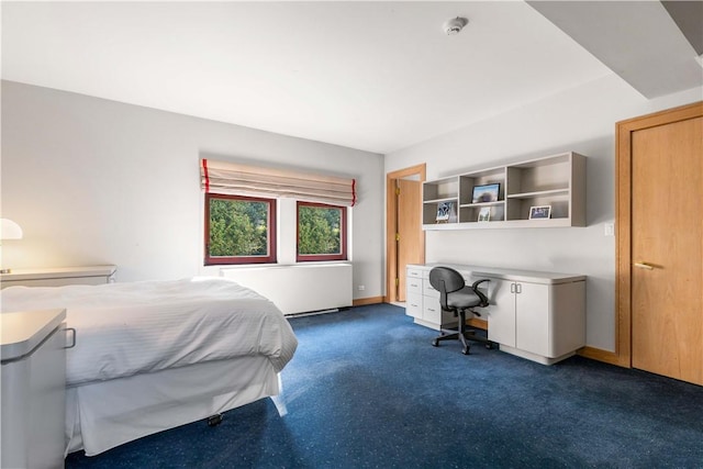 carpeted bedroom featuring radiator