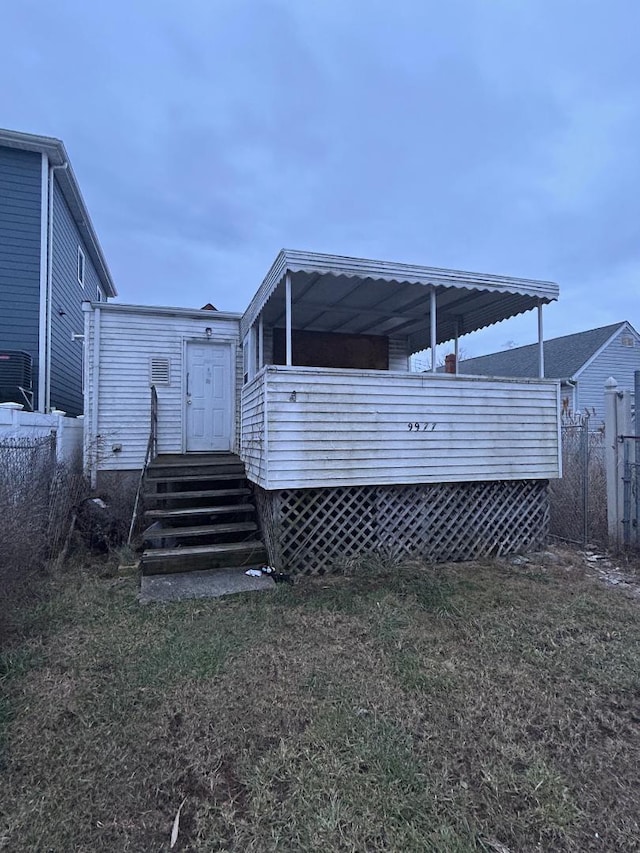 rear view of house with a lawn