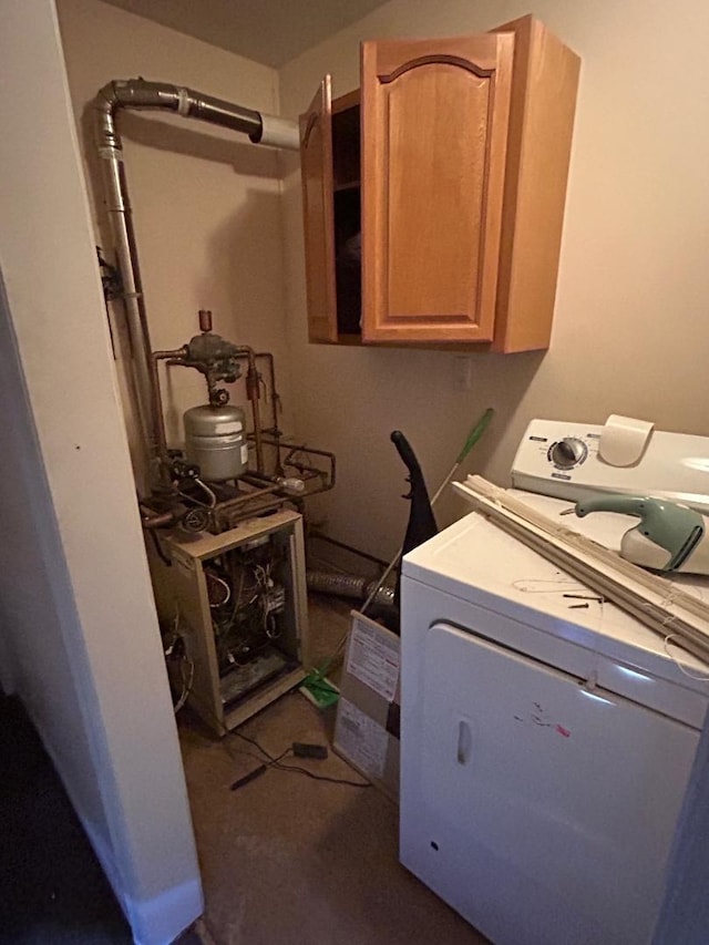 laundry room featuring cabinets and washer / clothes dryer