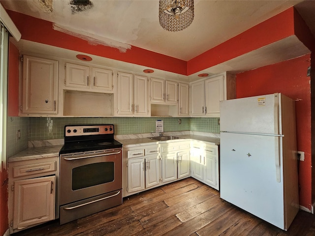 kitchen with stainless steel electric range oven, dark wood-type flooring, white fridge, decorative backsplash, and white cabinets