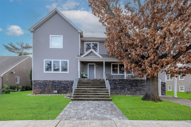 view of front of property with a front yard and covered porch