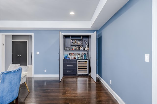 bar featuring dark wood-type flooring and beverage cooler