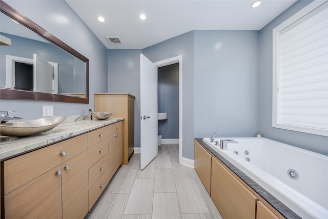 bathroom with a bath and vanity