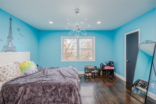 bedroom featuring dark hardwood / wood-style flooring and a chandelier