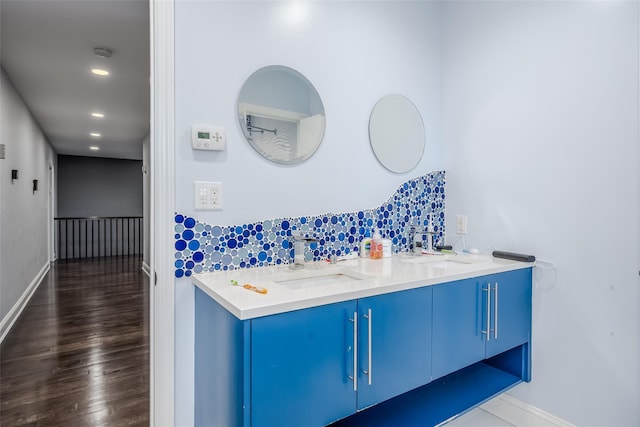 bathroom featuring vanity and tasteful backsplash