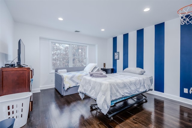 bedroom with dark hardwood / wood-style flooring