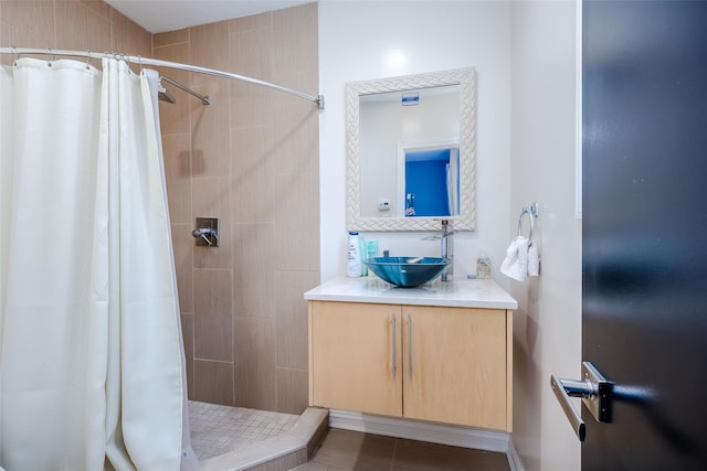 bathroom with tile patterned floors, vanity, and walk in shower