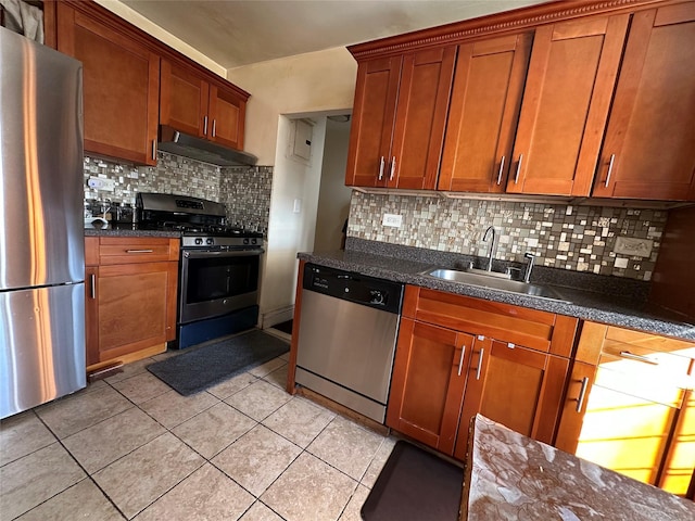 kitchen with light tile patterned flooring, sink, stainless steel appliances, and tasteful backsplash