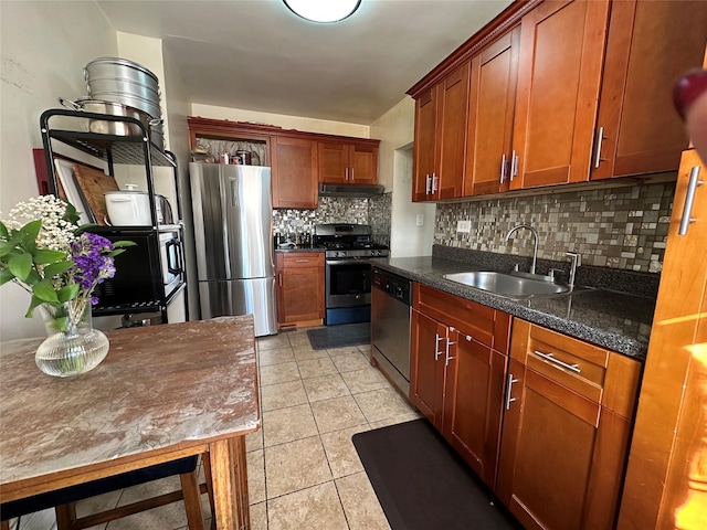 kitchen featuring decorative backsplash, light tile patterned floors, sink, and appliances with stainless steel finishes