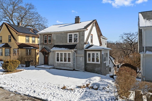 view of snow covered back of property