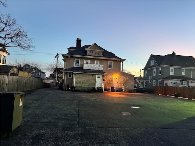 view of back house at dusk