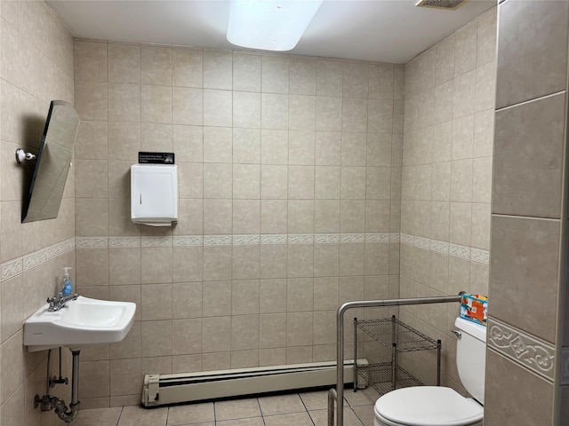 bathroom featuring tile patterned flooring, toilet, tile walls, and a baseboard heating unit