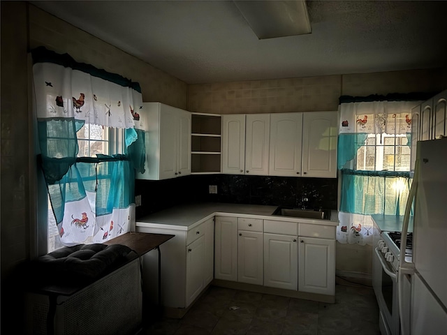 kitchen with white cabinets, decorative backsplash, white appliances, and sink