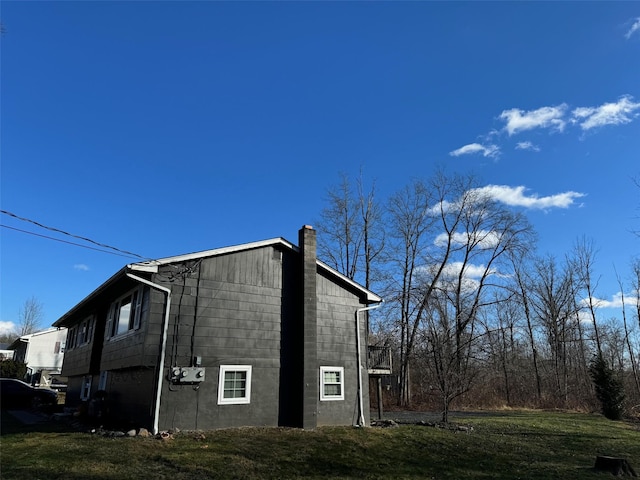 view of side of property with a lawn