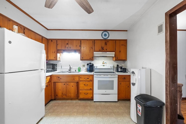 kitchen featuring ceiling fan, white appliances, sink, and tasteful backsplash