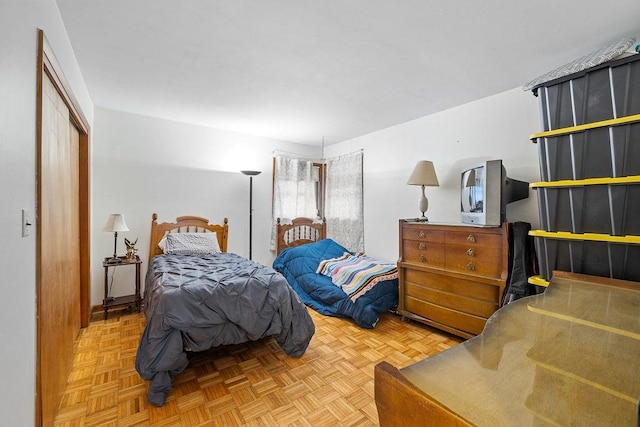 bedroom featuring parquet flooring