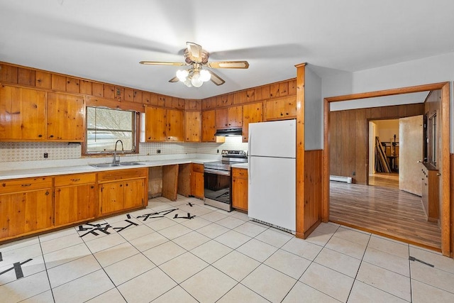 kitchen with a baseboard heating unit, white refrigerator, electric stove, sink, and ceiling fan