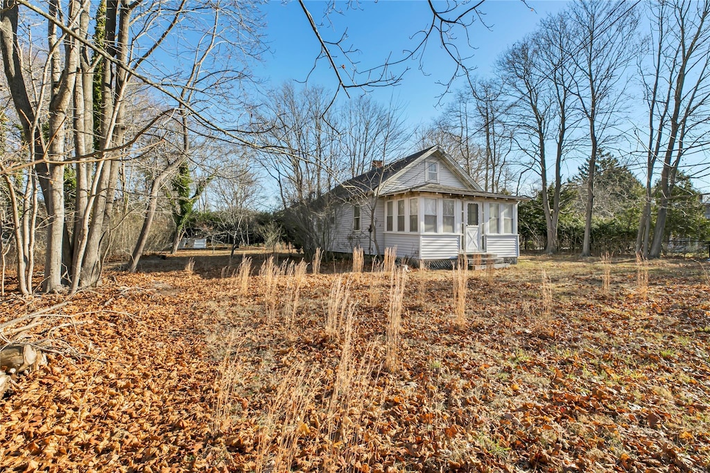 view of side of property with a sunroom