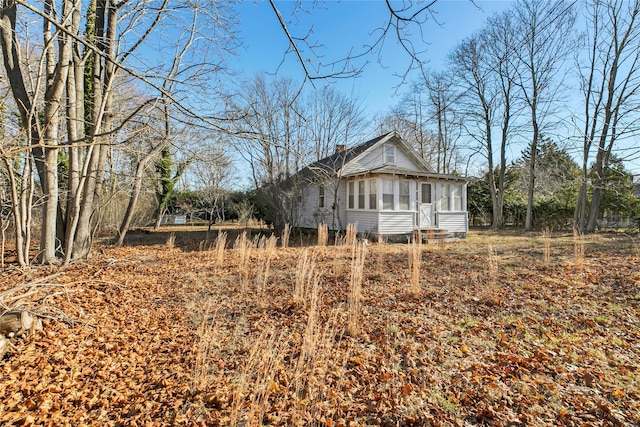 view of side of property with a sunroom