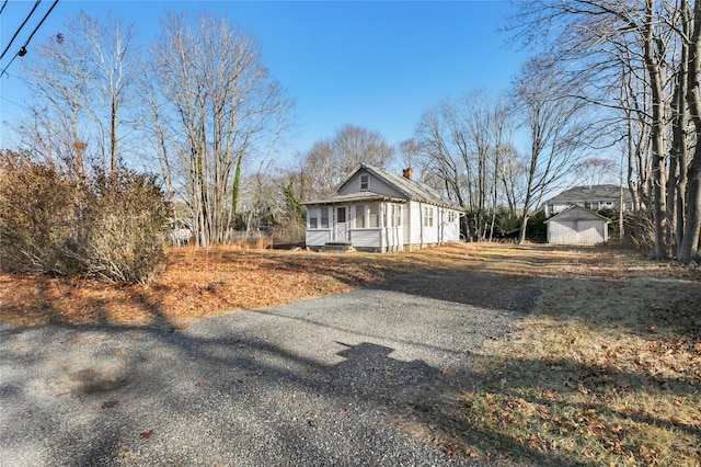 view of home's exterior featuring an outbuilding