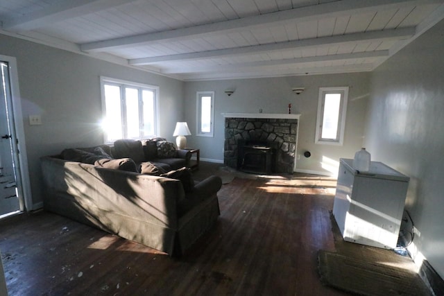 living room with beam ceiling, a wood stove, and dark wood-type flooring