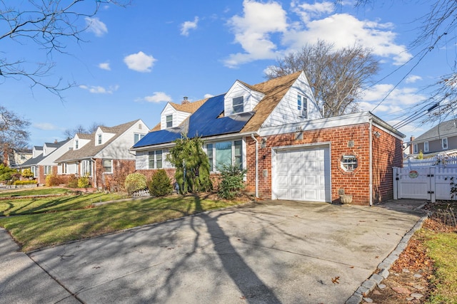 cape cod home featuring a front lawn