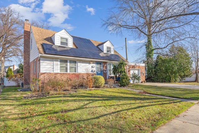 cape cod house featuring solar panels, a garage, and a front lawn