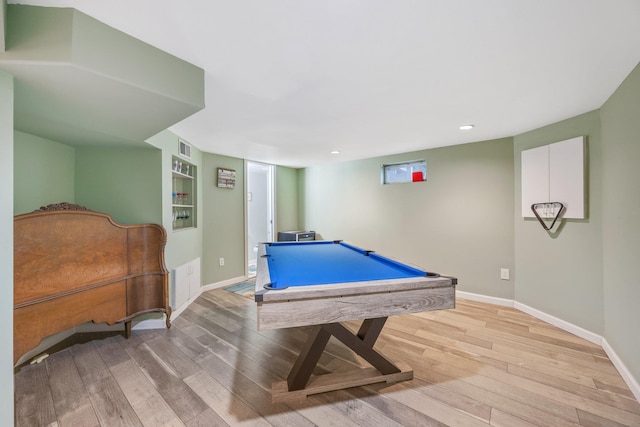 playroom with light hardwood / wood-style floors, built in features, and pool table