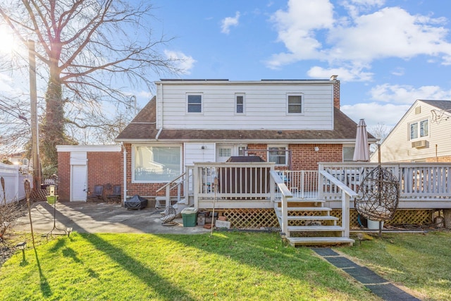 rear view of house featuring a lawn and a wooden deck