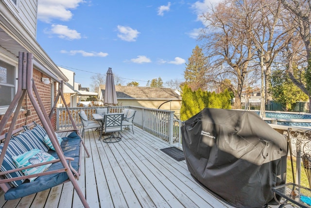 wooden terrace featuring grilling area