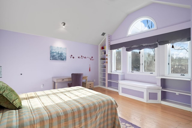 bedroom featuring light hardwood / wood-style floors and vaulted ceiling