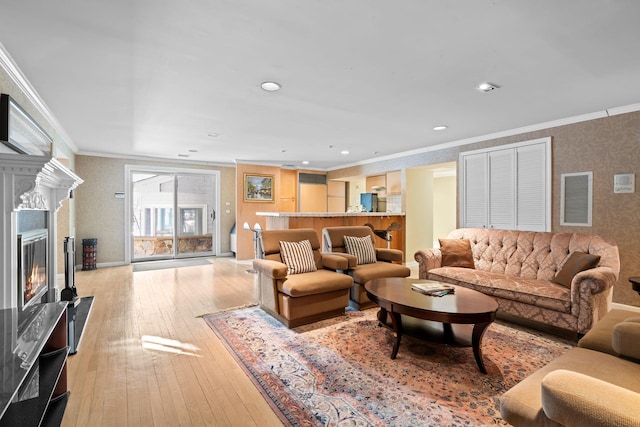 living room featuring ornamental molding and light hardwood / wood-style flooring