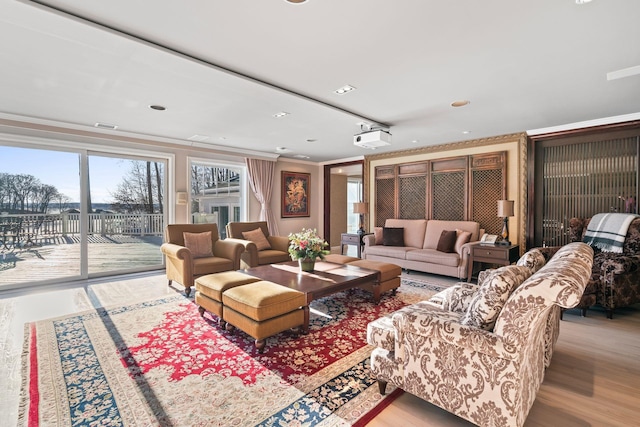 living room with light hardwood / wood-style floors and ornamental molding