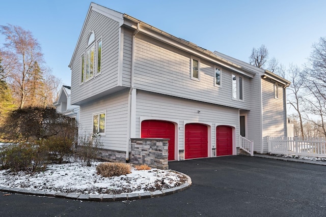 view of snowy exterior with a garage