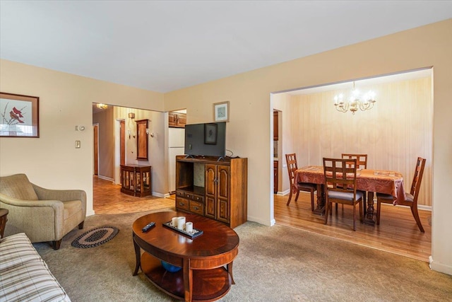 living room featuring carpet floors and a chandelier