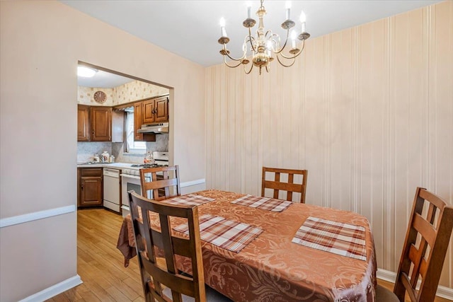 dining room with a notable chandelier and light hardwood / wood-style floors