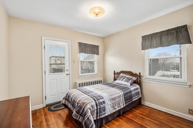 bedroom with radiator and dark hardwood / wood-style floors